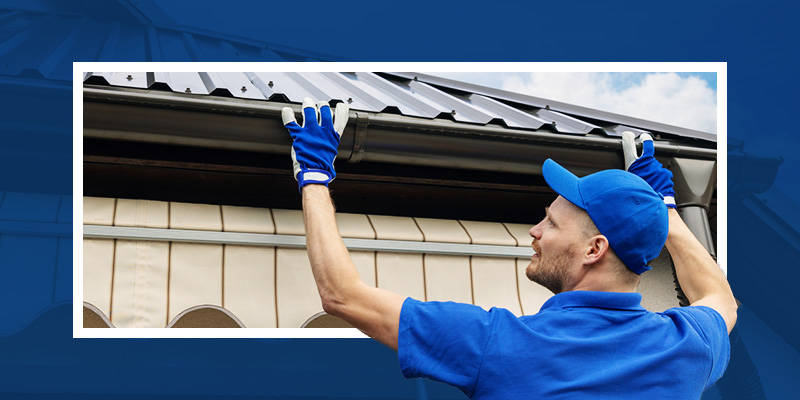 Man installing gutters on a home.